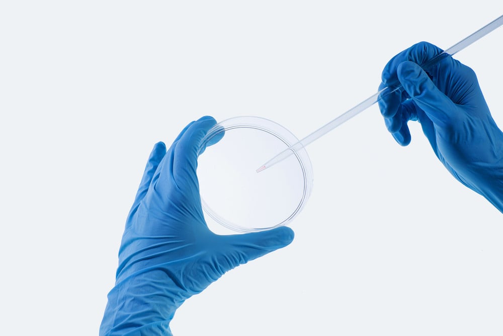 Close up image of scientist hands holding droplet