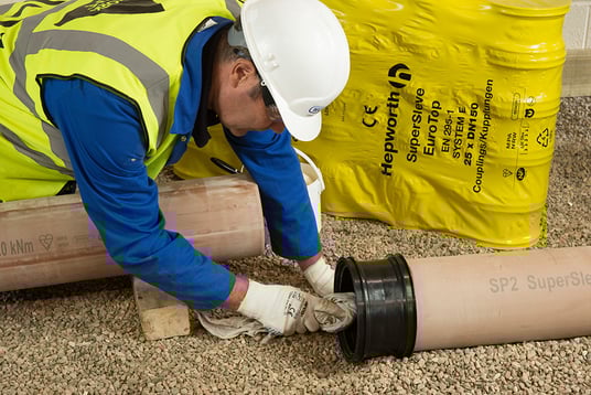 installation of a sewage plastic pipe during the construction of a house. Creative Banner. Copyspace image