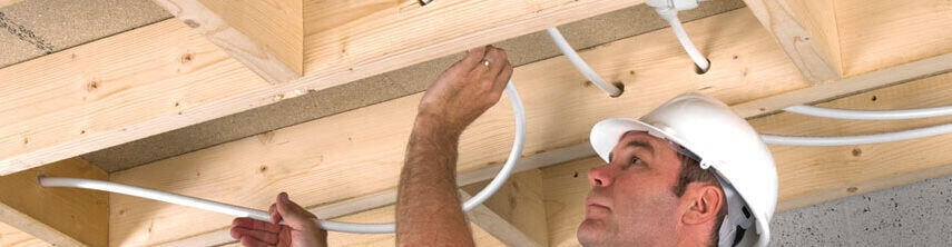 Man installing hep2O in ceiling header