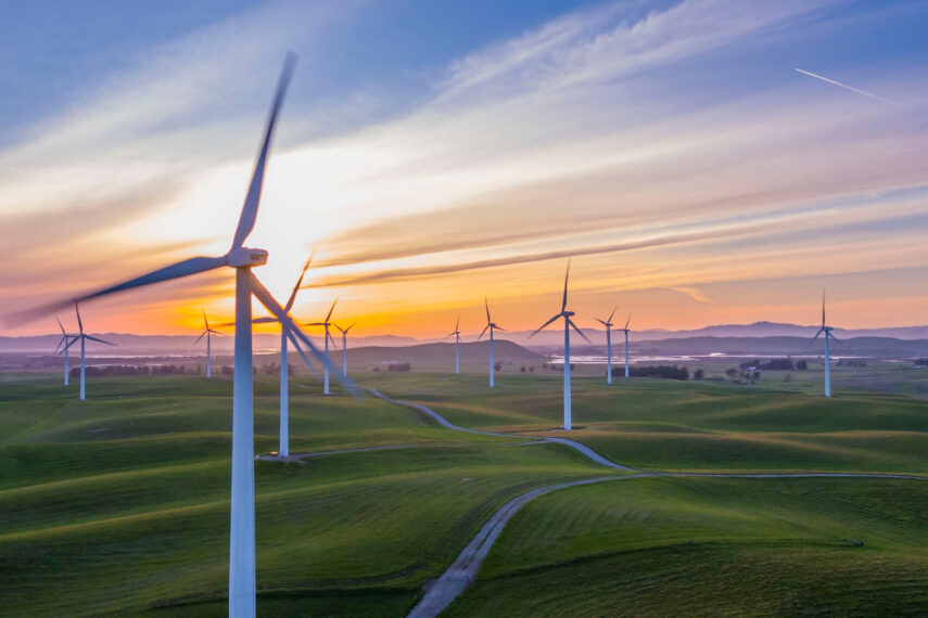 Wind turbine on fields sunset