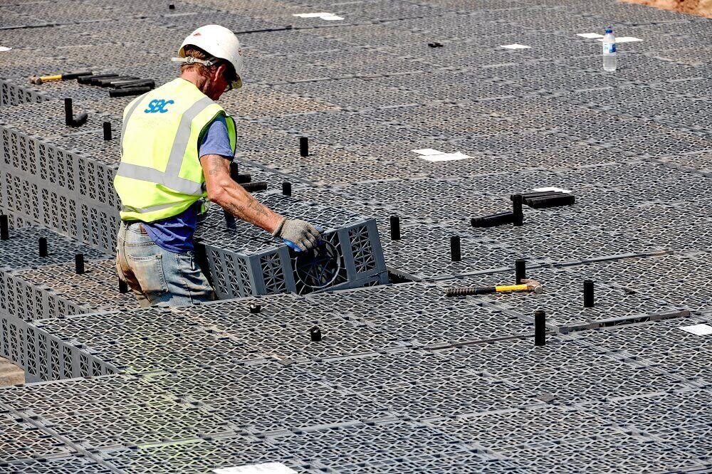 construction worker installing another aquacell crate
