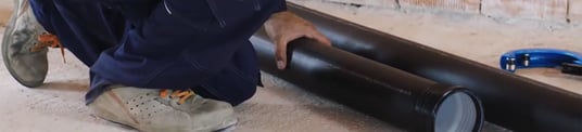 installation of a sewage plastic pipe during the construction of a house. Creative Banner. Copyspace image