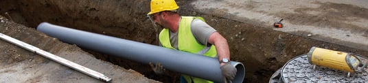 installation of a sewage plastic pipe during the construction of a house. Creative Banner. Copyspace image