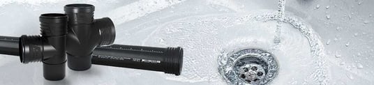 installation of a sewage plastic pipe during the construction of a house. Creative Banner. Copyspace image