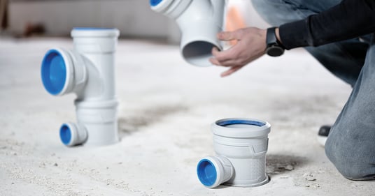 installation of a sewage plastic pipe during the construction of a house. Creative Banner. Copyspace image