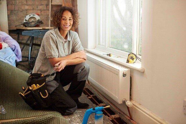 Woman plumber sitting down